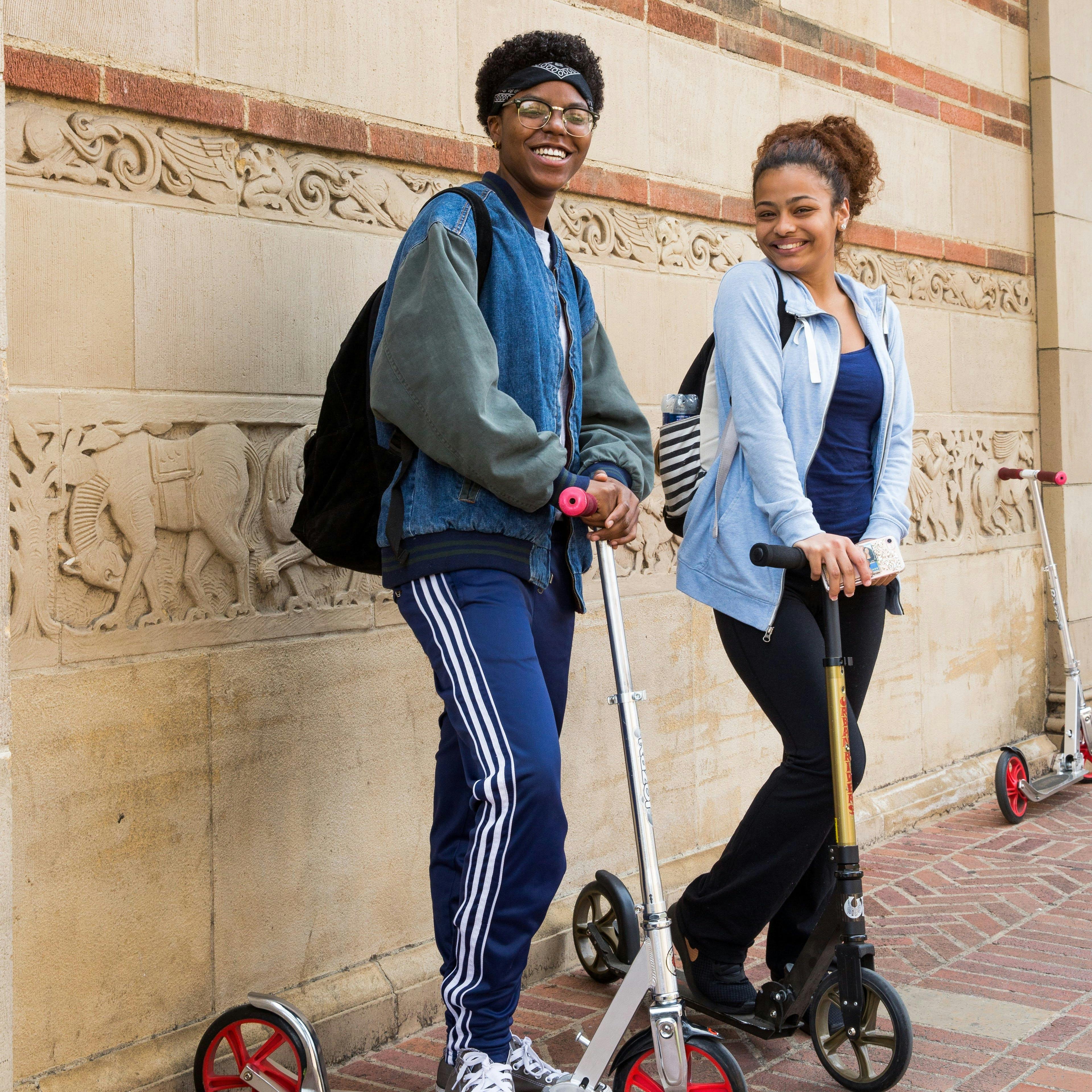 students riding a scooter